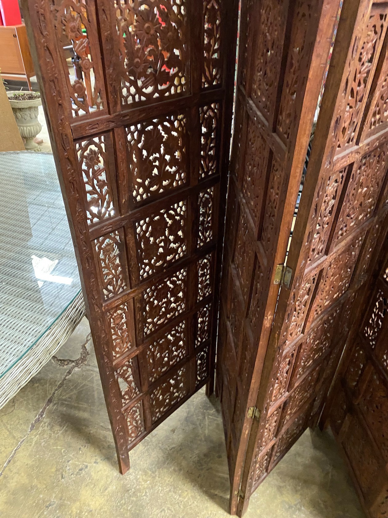 An Indian carved hardwood four fold screen, each panel width 51cm, height 183cm